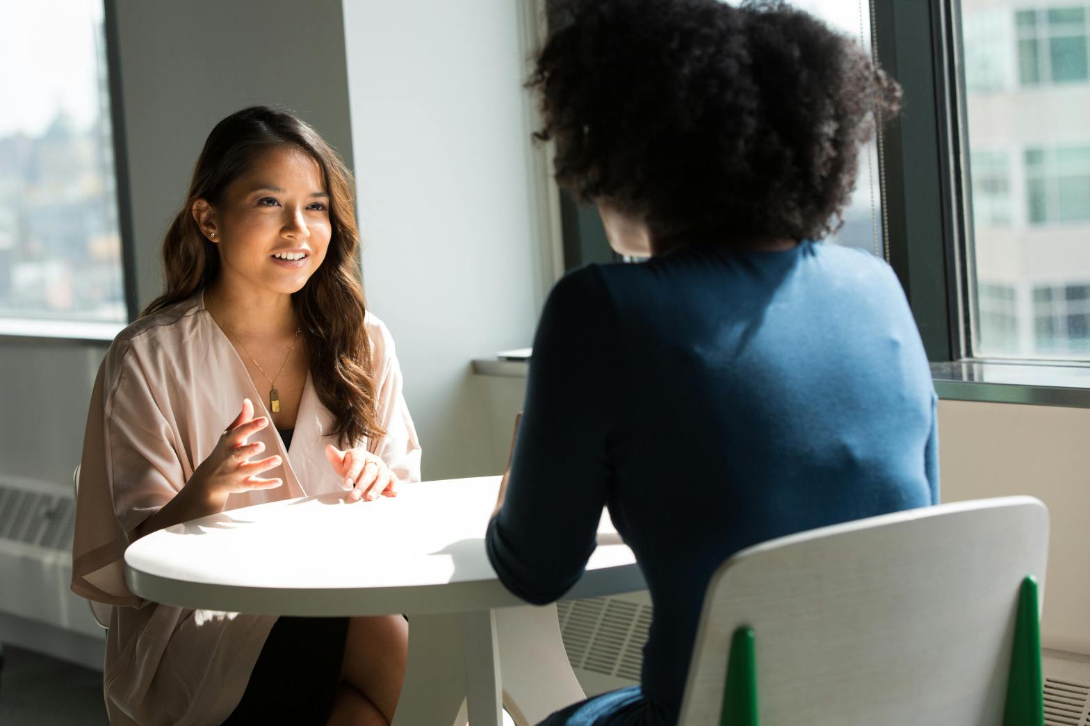Women talking to each other on a table
